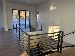 Staircase featuring wood finished floors and baseboards