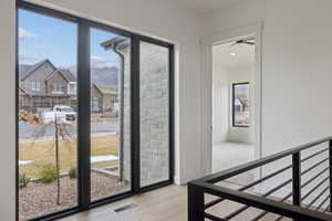 Doorway to outside featuring healthy amount of natural light, wood finished floors, a mountain view, and recessed lighting