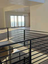 Staircase featuring a chandelier and baseboards