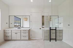 Bathroom featuring vanity and hanging lights