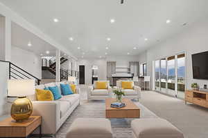 Carpeted living room with stairway and recessed lighting