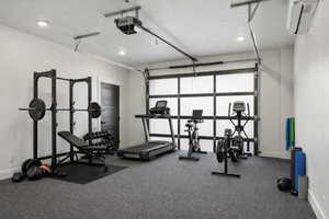 Workout area featuring recessed lighting and a garage