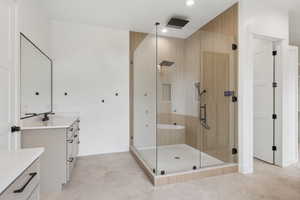 Full bathroom with vanity, a stall shower, and recessed lighting