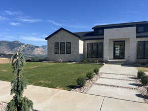 View of front facade with a front yard and a mountain view