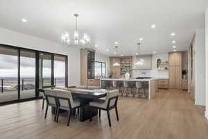 Dining area featuring light wood-style floors and hanging lights