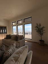 Living room with plenty of natural light, a mountain view, wood finished floors, and recessed lighting