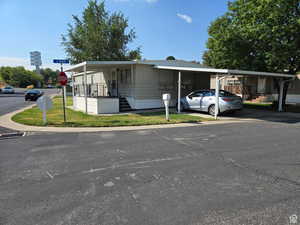 Manufactured / mobile home featuring stairway and driveway