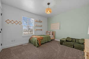 Carpeted bedroom featuring baseboards