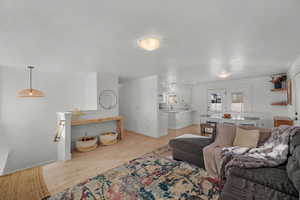 Living area featuring light wood finished floors and baseboards