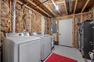 Laundry area with independent washer and dryer, concrete flooring, and electric panel