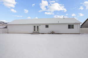 Snow covered house with french doors