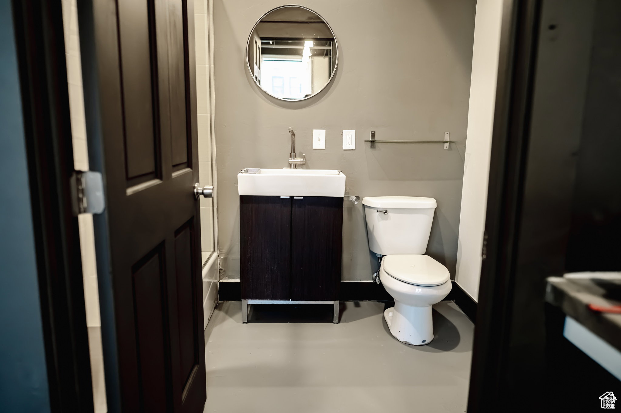 Bathroom with vanity and finished concrete flooring