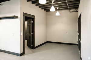 Empty room with concrete floors and baseboards