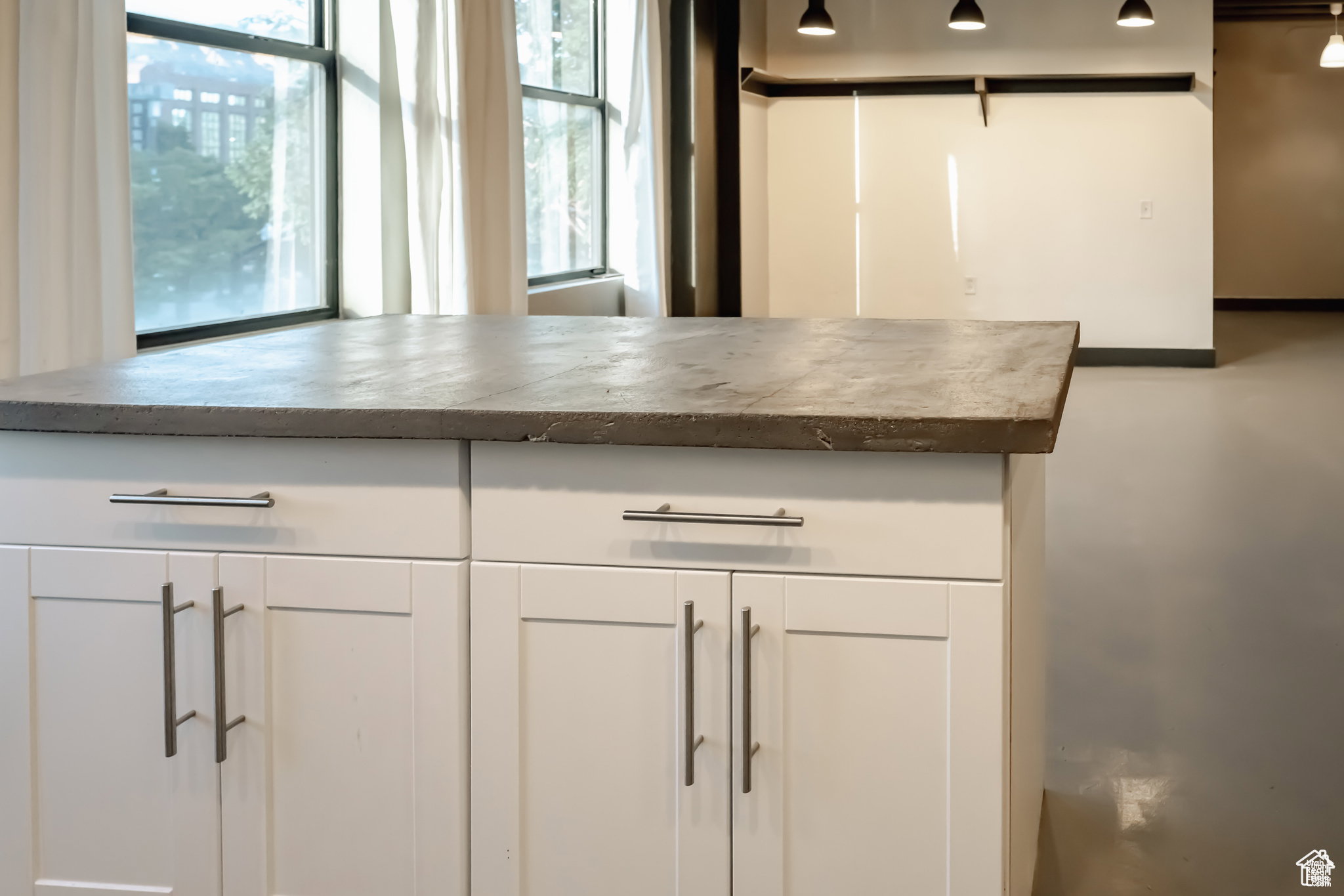 Detailed view of white cabinets and dark countertops