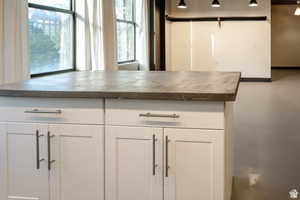 Detailed view of white cabinets and dark countertops