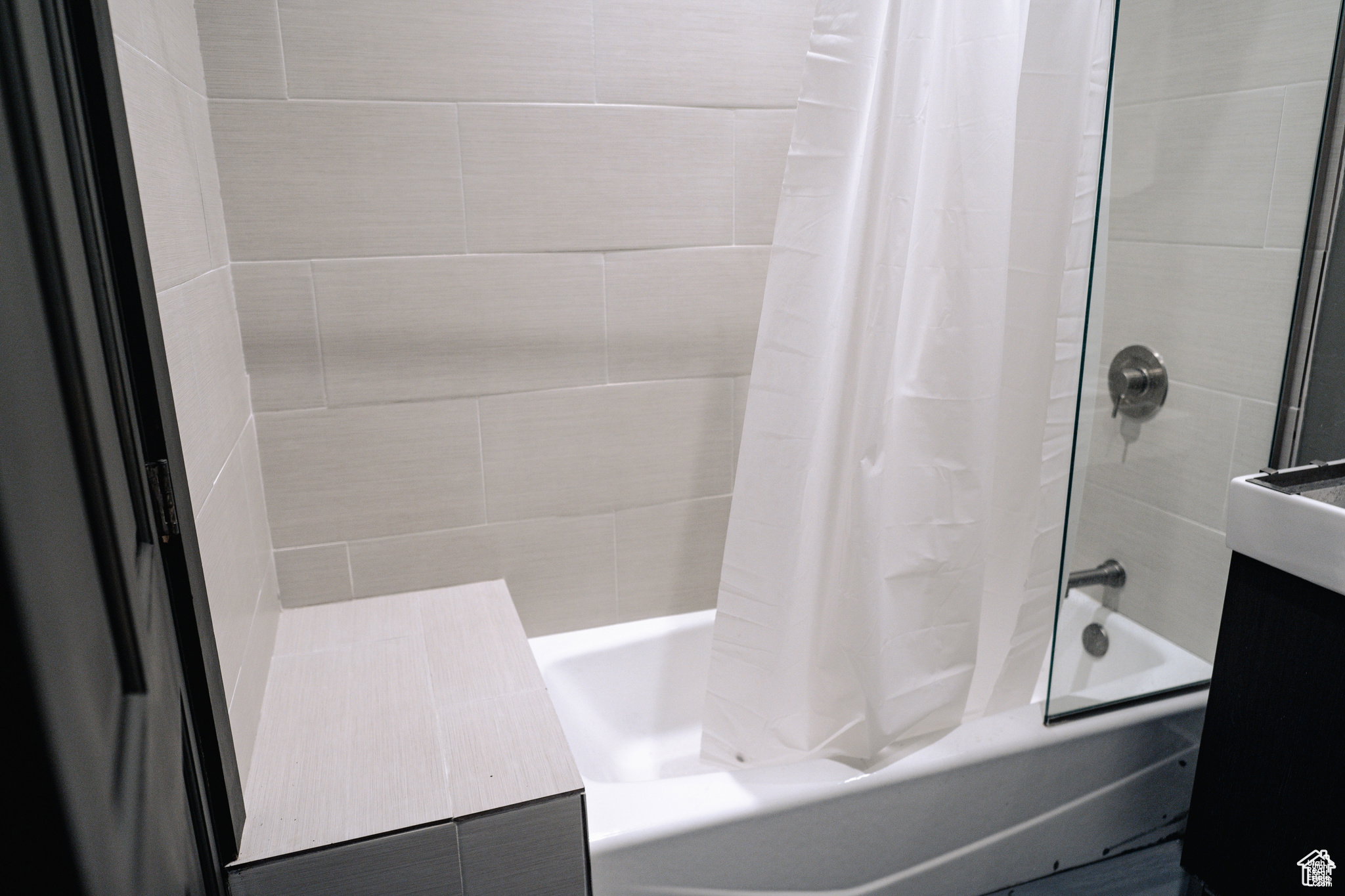 Full bathroom featuring shower / bath combination with curtain and vanity