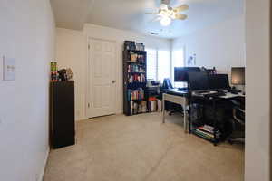 Office area featuring light carpet and ceiling fan