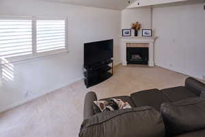 Living room featuring light carpet and a tile fireplace