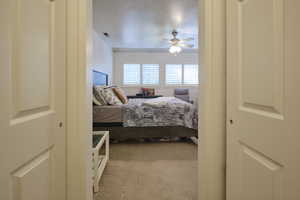 Bedroom with carpet floors and a ceiling fan