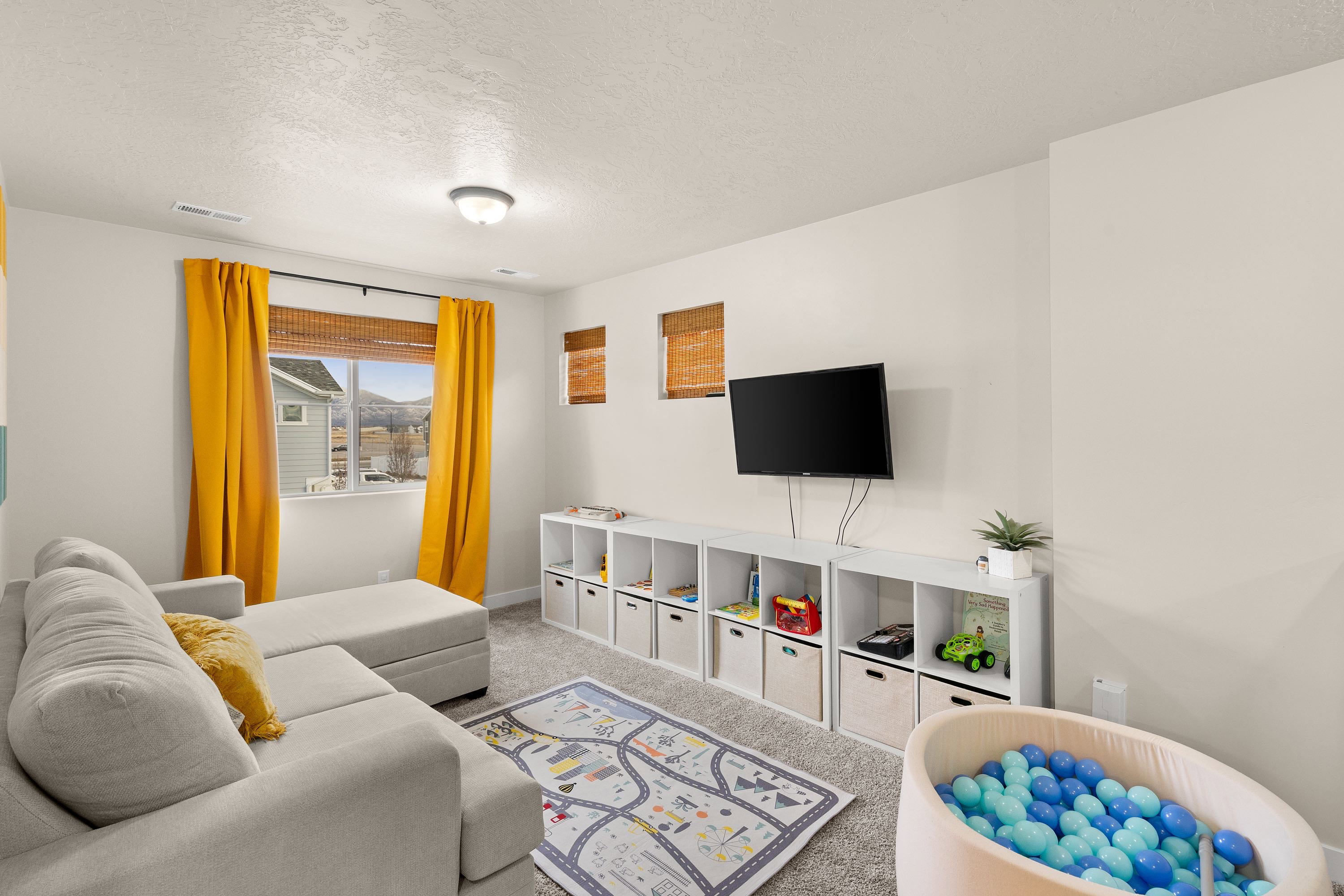 Living area featuring carpet floors and a textured ceiling