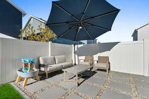 Fenced backyard with an outdoor hangout area and a patio