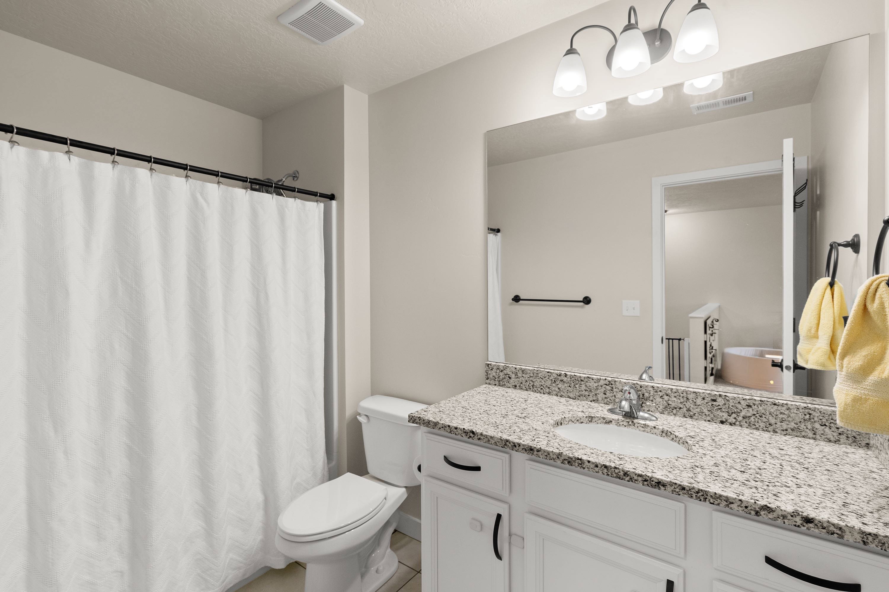 Full bath featuring vanity and a shower