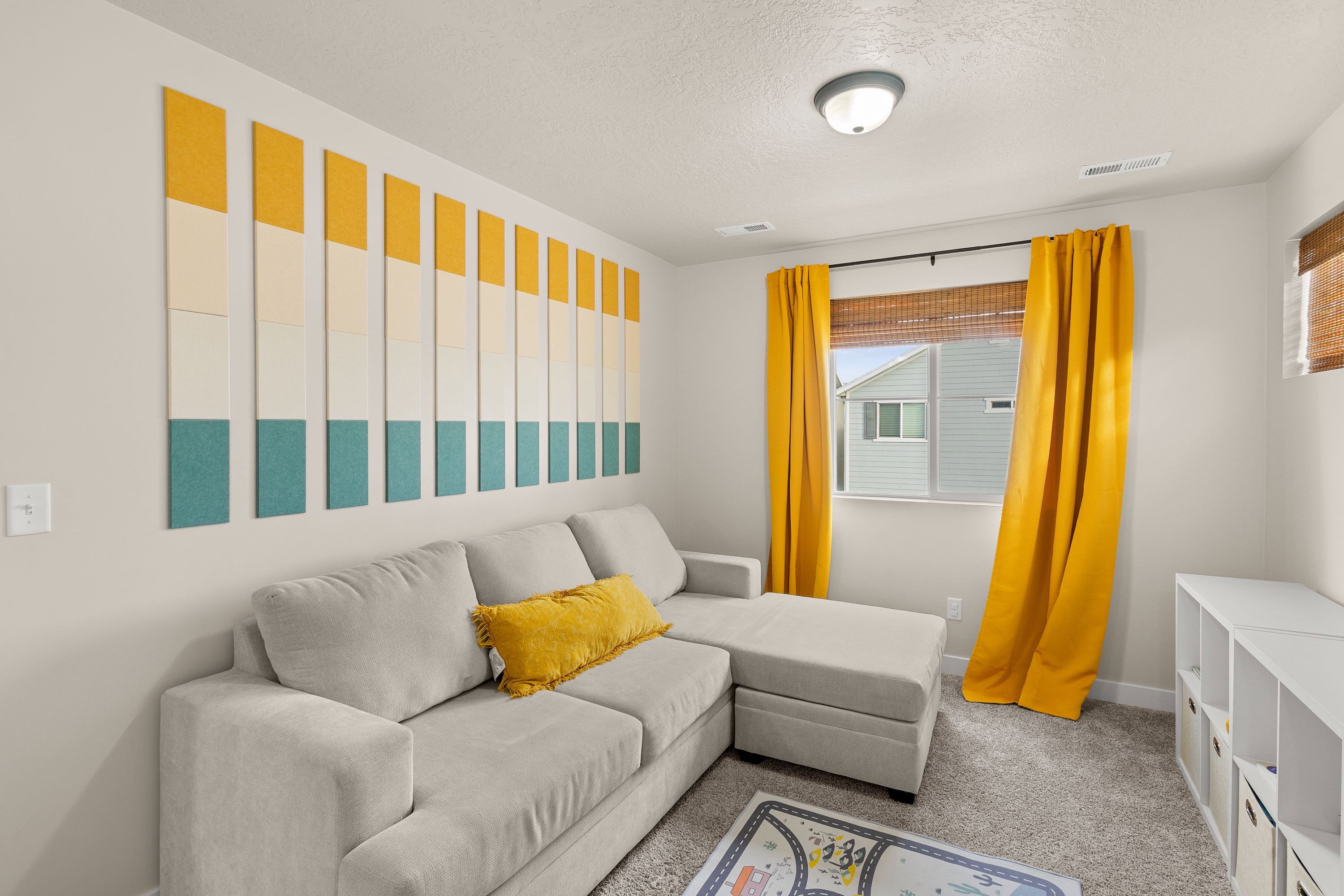 Carpeted living room featuring a textured ceiling and baseboards