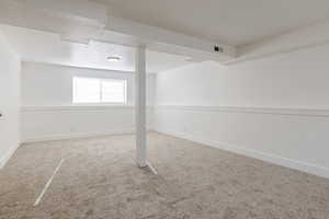 Below grade area featuring carpet floors and a textured ceiling