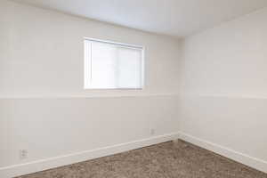 Spare room featuring baseboards