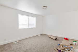Unfurnished room with carpet and baseboards
