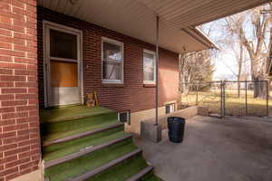 View of patio featuring a gate