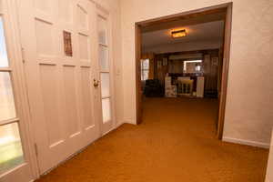 Hall with carpet and baseboards