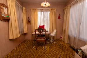 Living area with a chandelier and baseboards