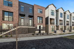 View of front of home featuring board and batten siding and brick siding