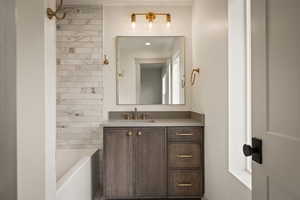 Bathroom with vanity and bathing tub / shower combination
