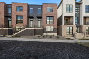 View of front of house featuring board and batten siding and brick siding