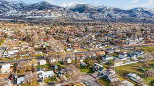 Aerial overview of property's location with a mountainous background and nearby suburban area