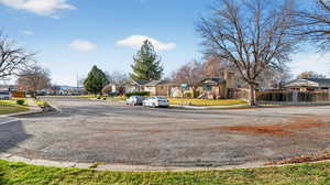 View of asphalt road featuring sidewalks, a residential view, and curbs