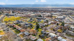 Aerial view of property and surrounding area with nearby suburban area