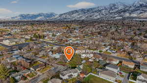 Aerial view of property's location featuring nearby suburban area and mountains