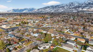 Aerial overview of property's location with nearby suburban area and a mountainous background