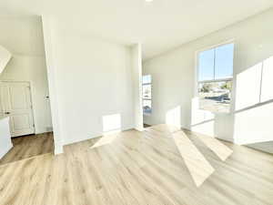 Unfurnished living room featuring light wood-style flooring and a textured ceiling