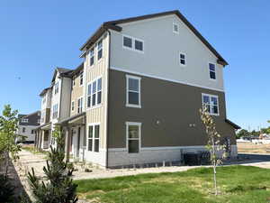 View of home's exterior with a central air condition unit and brick siding
