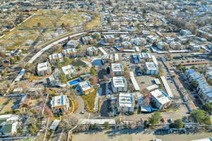 Aerial view of property and surrounding area with nearby suburban area