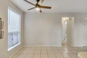 Dining area featuring a ceiling fan and light tile patterned floors
