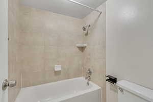 Full bath featuring tub / shower combination and toilet