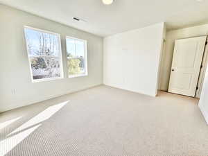 Carpeted spare room with baseboards and a textured ceiling