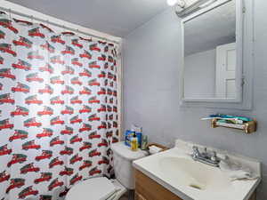 #39 (Basement 1-bedroom): Bathroom featuring vanity, and curtained shower