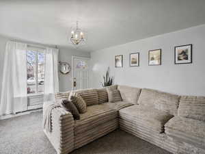 #37 (Upstairs 2-bedroom): Living area featuring carpet flooring and lots of natural light