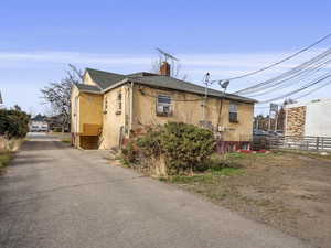 View private driveway to off street parking; view of rear of the property; left entrance is the 1 bedroom basement unit #39; right entrance is to the shared laundry and studio apartment unit #29